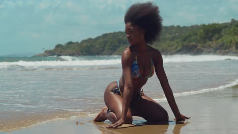 a bikini girl with curly hair immerses herself in the beauty of a tropical caribbean island beach on a sunny day with ocean waves in the background