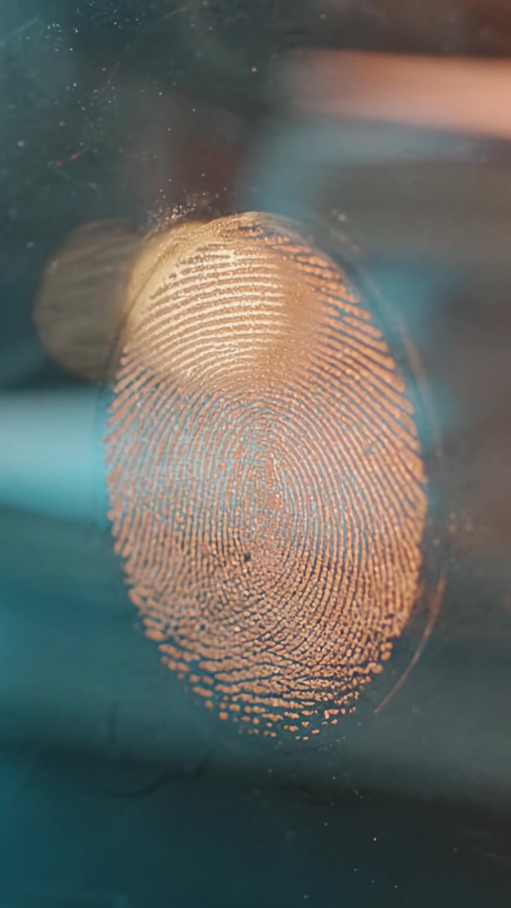 Exploring the Intricacies of a Fingerprint: A Close-Up View Capturing Unique Patterns and Textures with Light Reflections and Soft Background Colors