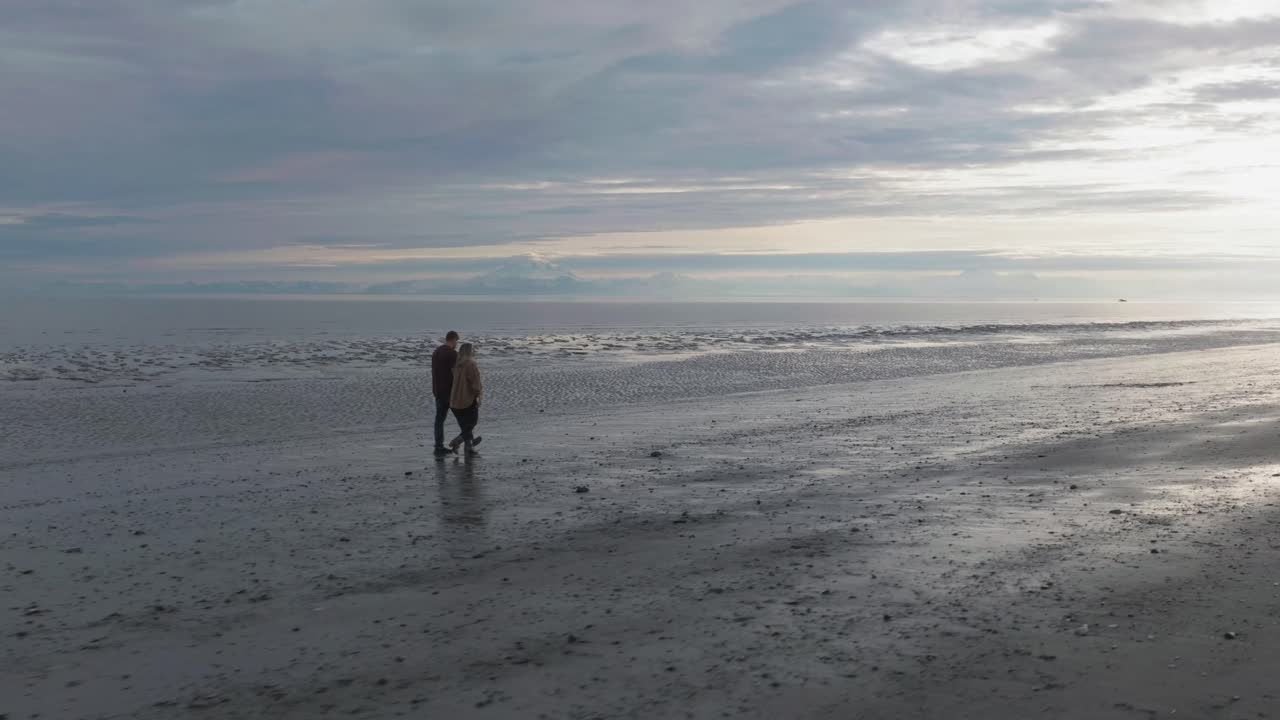 Couple walking on beach in Kenai, Alaska