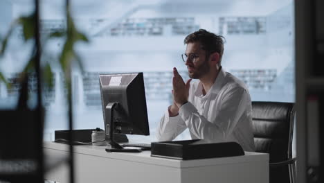 A-serious-man-sits-at-a-computer-in-the-office-and-thinks.-Analyzes-solves-a-crisis-problem.-A-difficult-stage-in-business.-Thoughtful-businessman