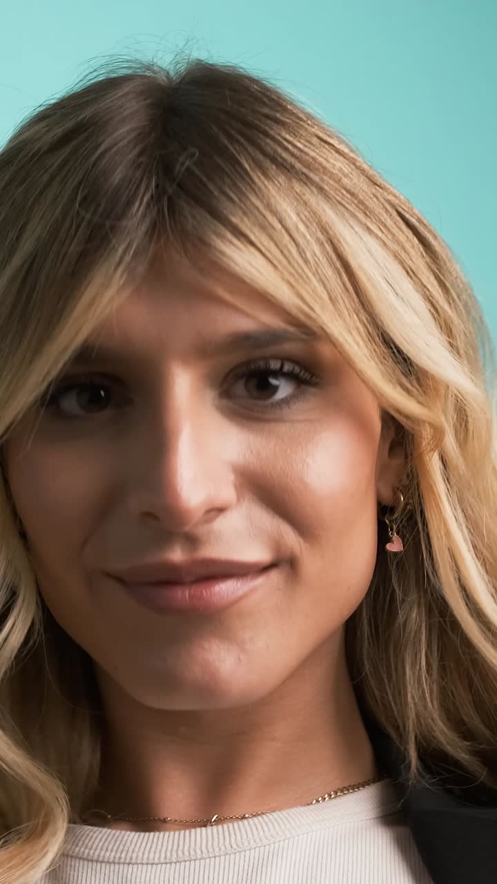 Happy transgender businesswoman playing with hair and puckering lips