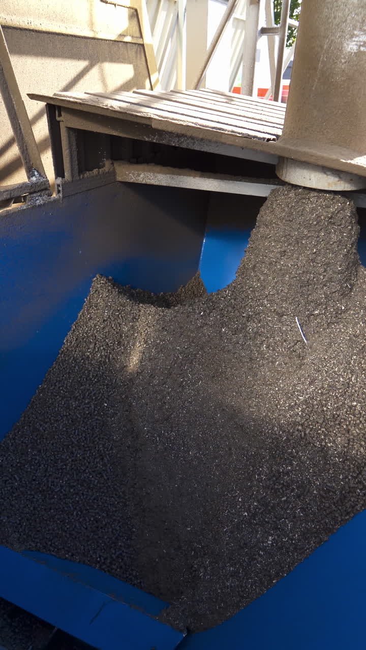 Grains on the industrial plant. Factory for keeping and processing agricultural products. Industrial equipment with compound feed. Vertical video