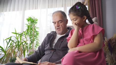 grandfather and grandson reading a book.