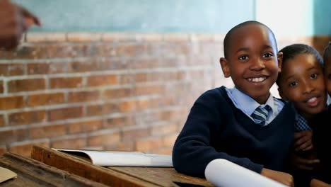 schoolkids looking at camera in the classroom 4k