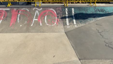 shadow of an athlete preparing to descend the ramp at the skatepark pool