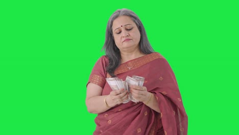 Indian-old-woman-counting-money-Green-screen