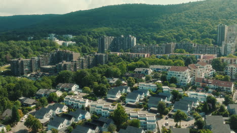 aerial: emmertsgrund neighborhood and cityscape during the day in heidelberg, state of baden-wurttemberg, germany, pull out drone shot