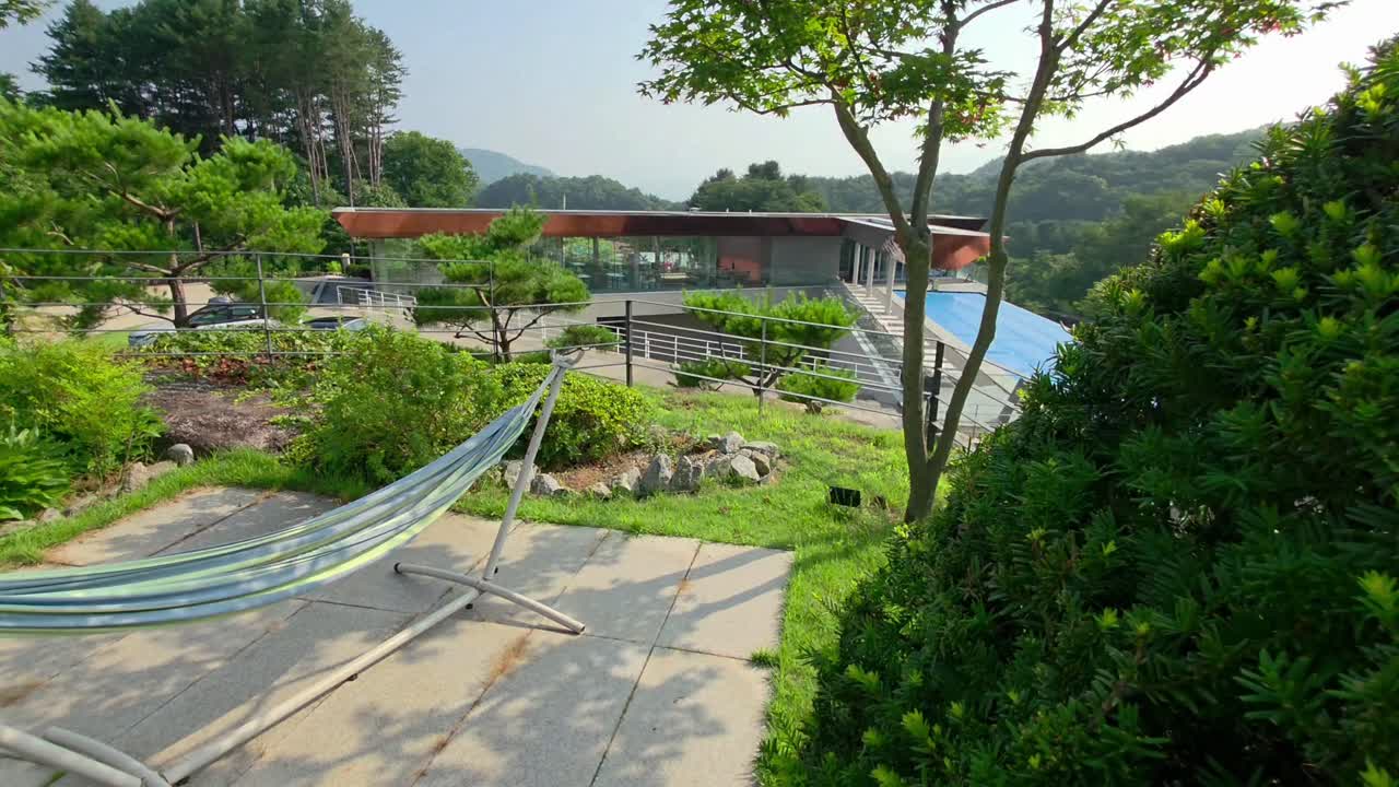 Modern glamping resort in Gapyeong featuring unique pavilions, infinity pool, mountain views, private gardens, and relaxing hammocks surrounded by lush nature