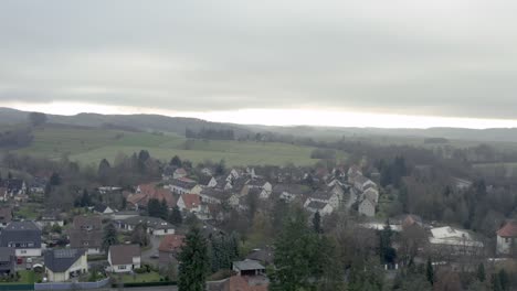 Drone-Aerial-view-of-the-traditional-german-village-Herzberg-am-Harz-in-the-famous-national-park-in-central-Germany-on-a-cloudy-day-in-winter.