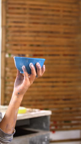 girl painting a bowl