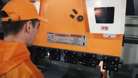 worker inspecting metal press brake