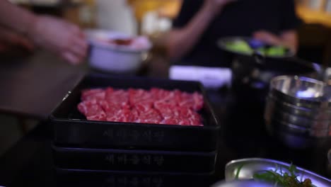 person serving beef at a restaurant table