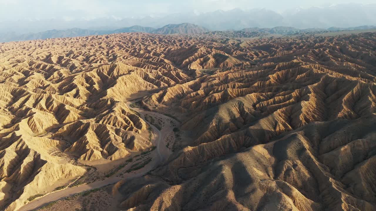 Aerial view of Ak Sai Canyons The Valley of Forgotten Rivers in Kyrgyzstan southern Issyl Kol lake at sunset wide angle drone