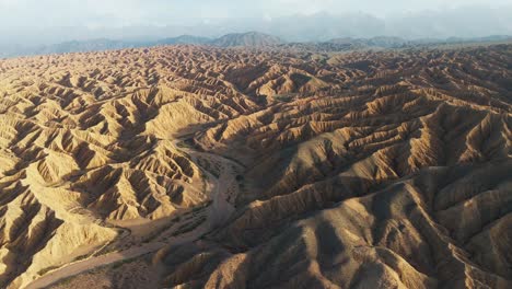 aerial view of ak sai canyons the valley of forgotten rivers in kyrgyzstan southern issyl kol lake at sunset wide angle drone