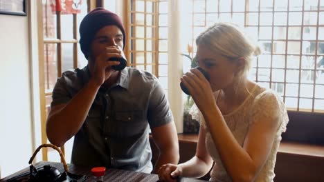 couple interacting with each other while having tea