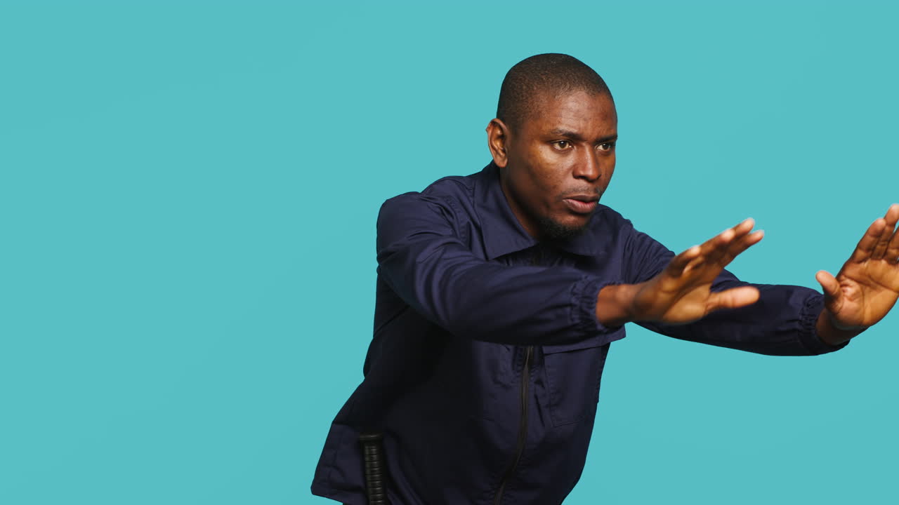 Portrait of stern bodyguard pushing back unwanted visitors