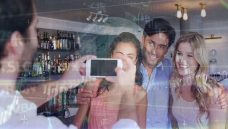 Animation-of-data-processing-over-caucasian-male-waiter-taking-picture-of-group-of-friends-at-a-bar