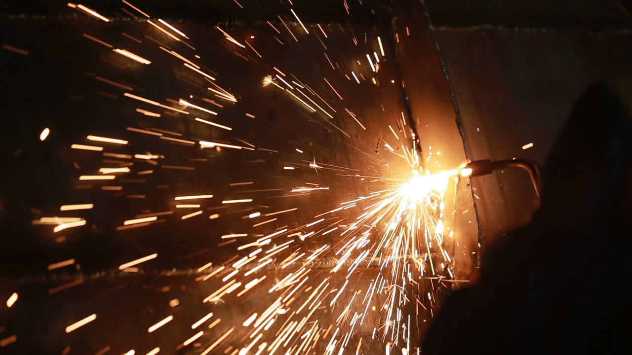 Steel welding blacksmith in factory. Workers cutting steel plates with gas cutter