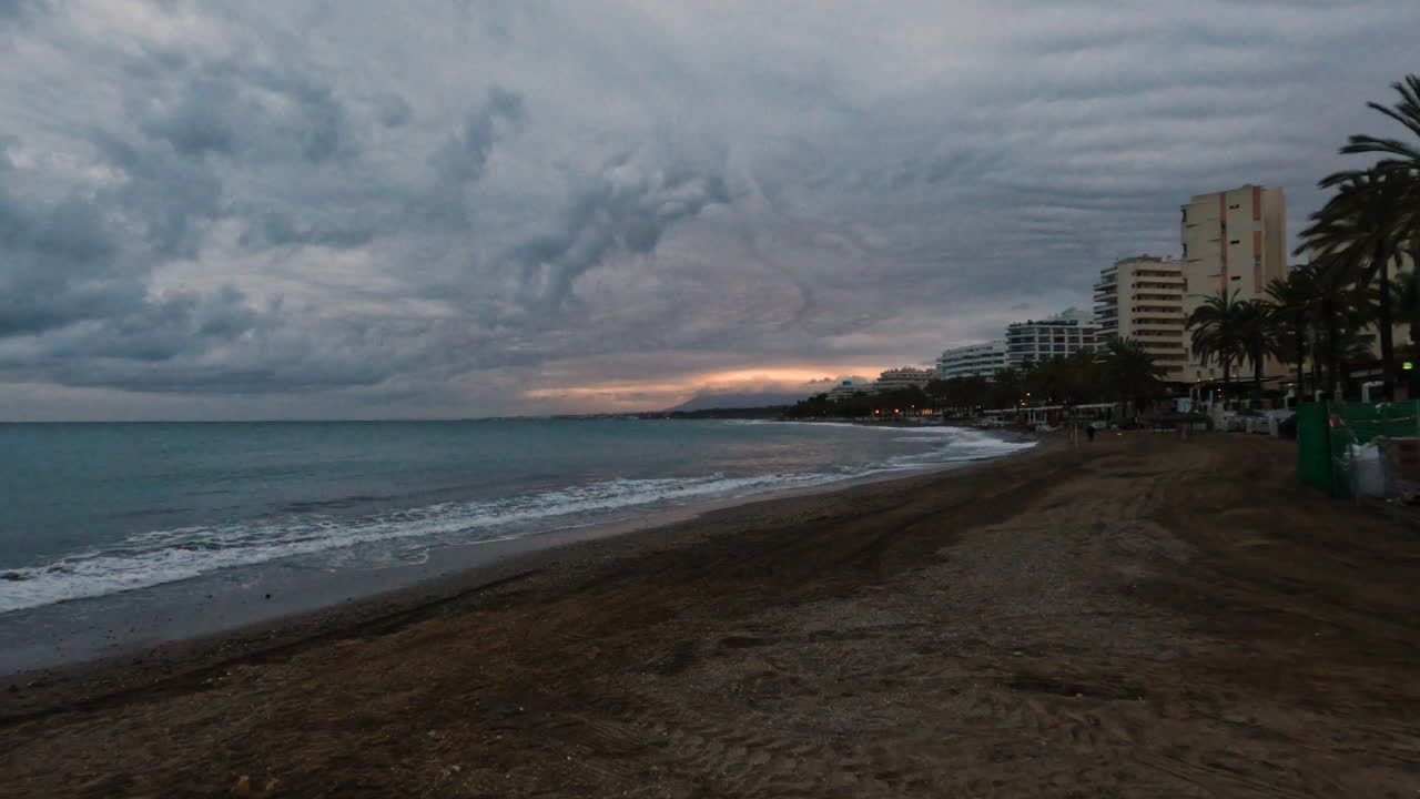 4k Shot of an empty beach at a luxury area on a cloudy evening at Marbella, Spain. Sunset
