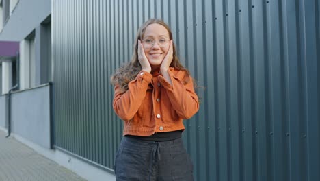 Woman-looks-shocked-at-joyful-surprise-hands-wrap-around-face-happy-and-excited