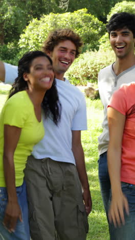 group of casual young friends putting their hands together
