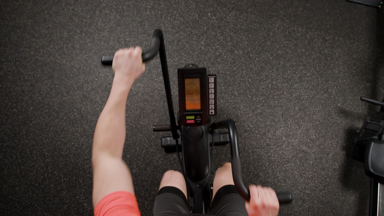 Person on an Exercise Bike in a Gym