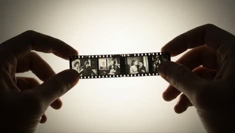 a captivating glimpse into the art of film photography: holding a vintage film strip showcasing moments frozen in time