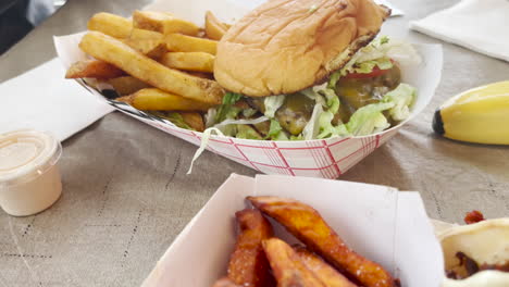 cheeseburger and fries and sweet potato fries, pullback shot