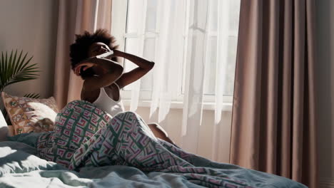 a woman waking up in bed in the morning
