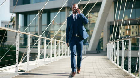 businessman walking on bridge and talking on the phone