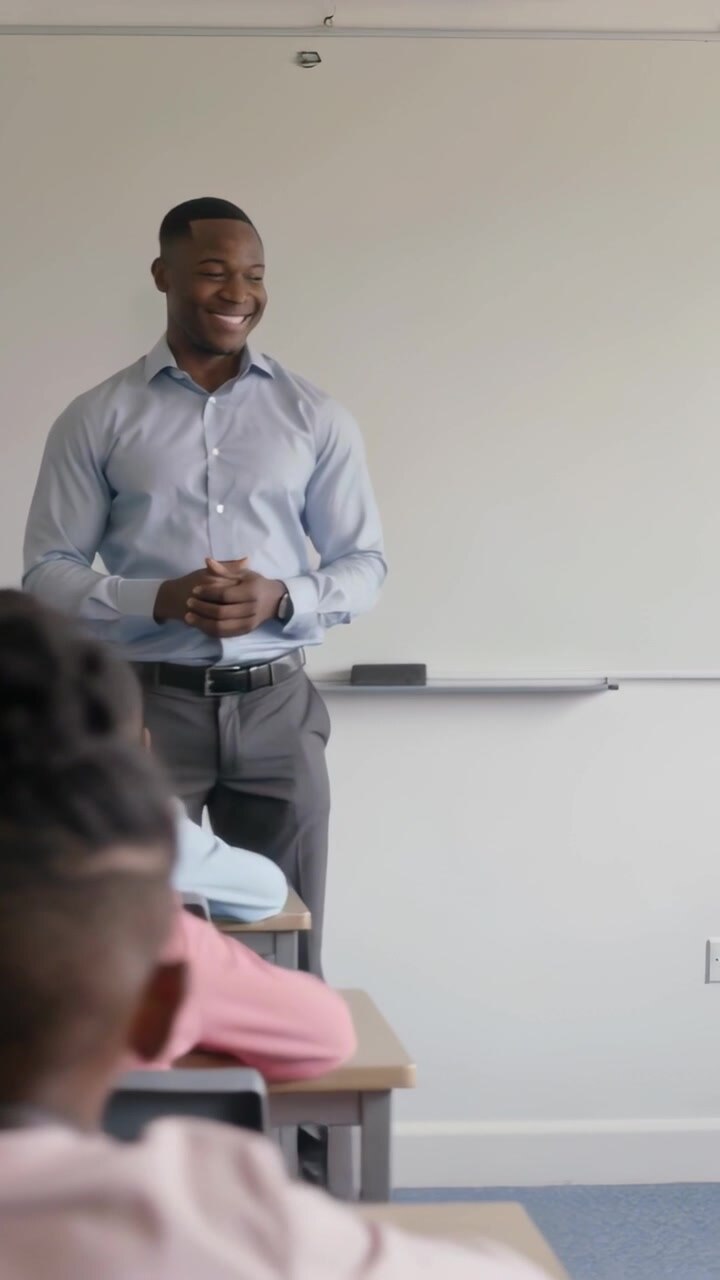Vertical video: Lesson starting, teacher in blue shirt, grey pants teaching at school using board