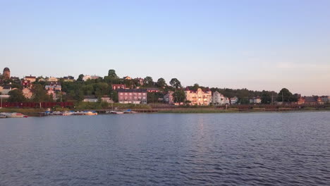 Country-side-lake-town-drone-low-to-the-ground-flyover-at-evening-golden-hour-time