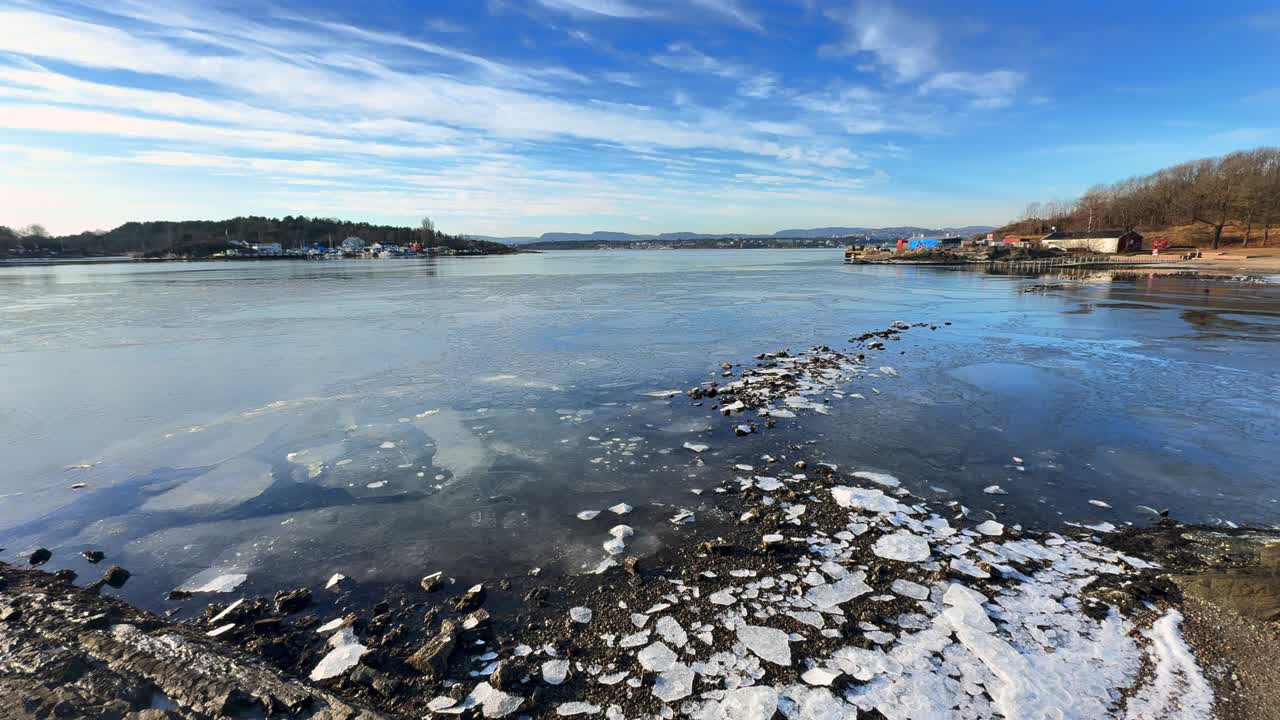 Early morning iced beach winter Hovedøya island Hovedoya small islands coast of Oslofjord Oslo Norway city center beautiful forests beaches cultural heritage site blue sky clouds clear sunny day pan