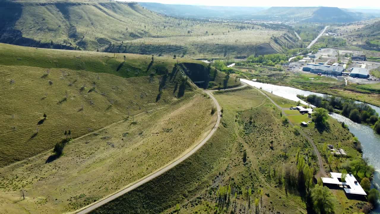 US, Oregon, Warm Springs, , 2025-04-19 - Drone view of an old abandoned train tunnel built in 1906 on the Deschutes River. Tthe railroad grade curves to the left and the tunnel in the center.