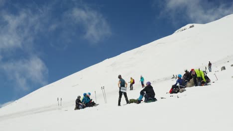 hikers resting on snowy mountain summit