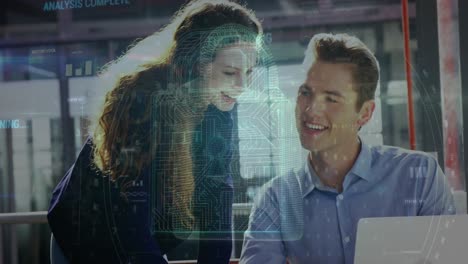 animation of security padlock icon over diverse male and female colleagues using laptop at office
