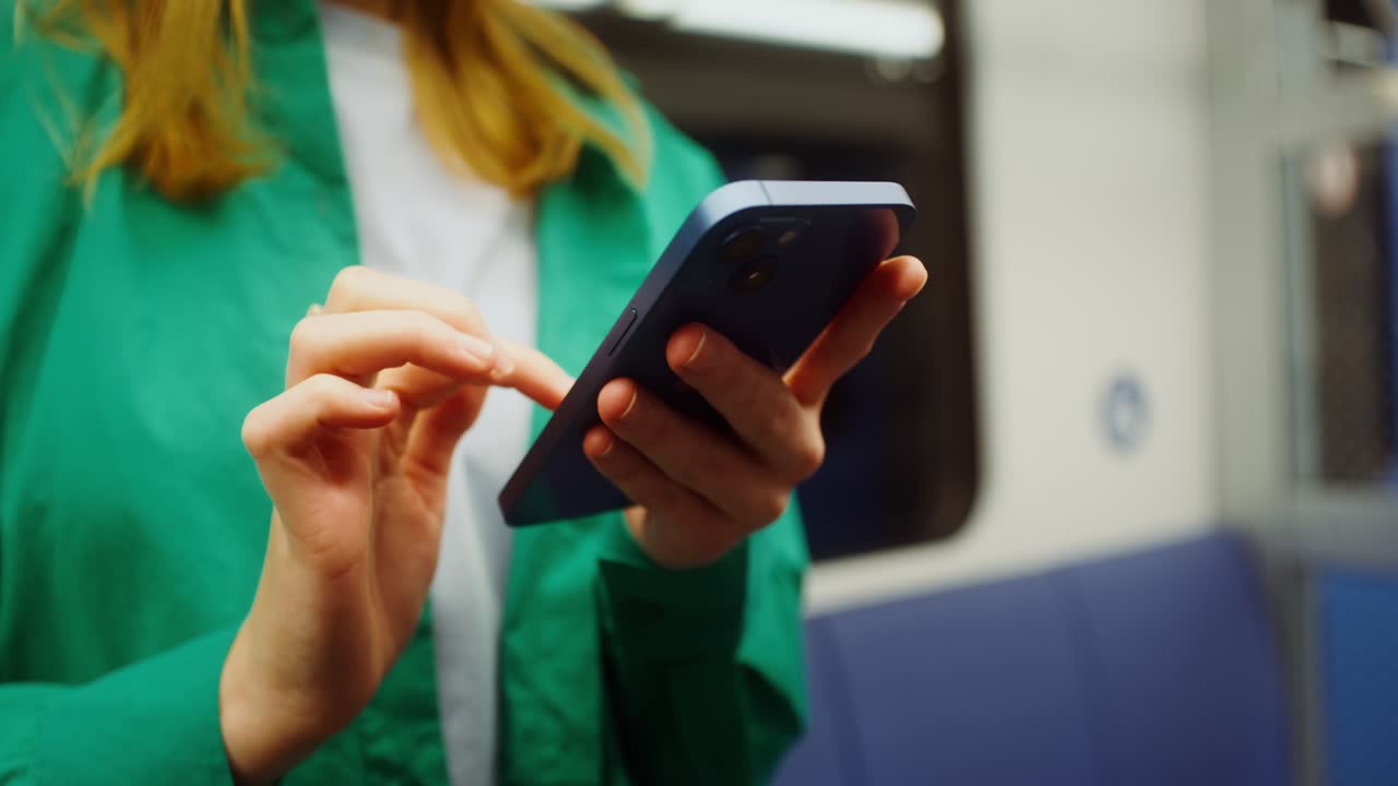 Woman using mobile phone on a train