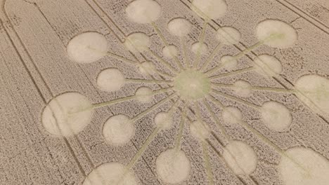 Andover crop circle formation aerial view rising rotation over atomic starburst pattern on Hampshire agricultural farmland
