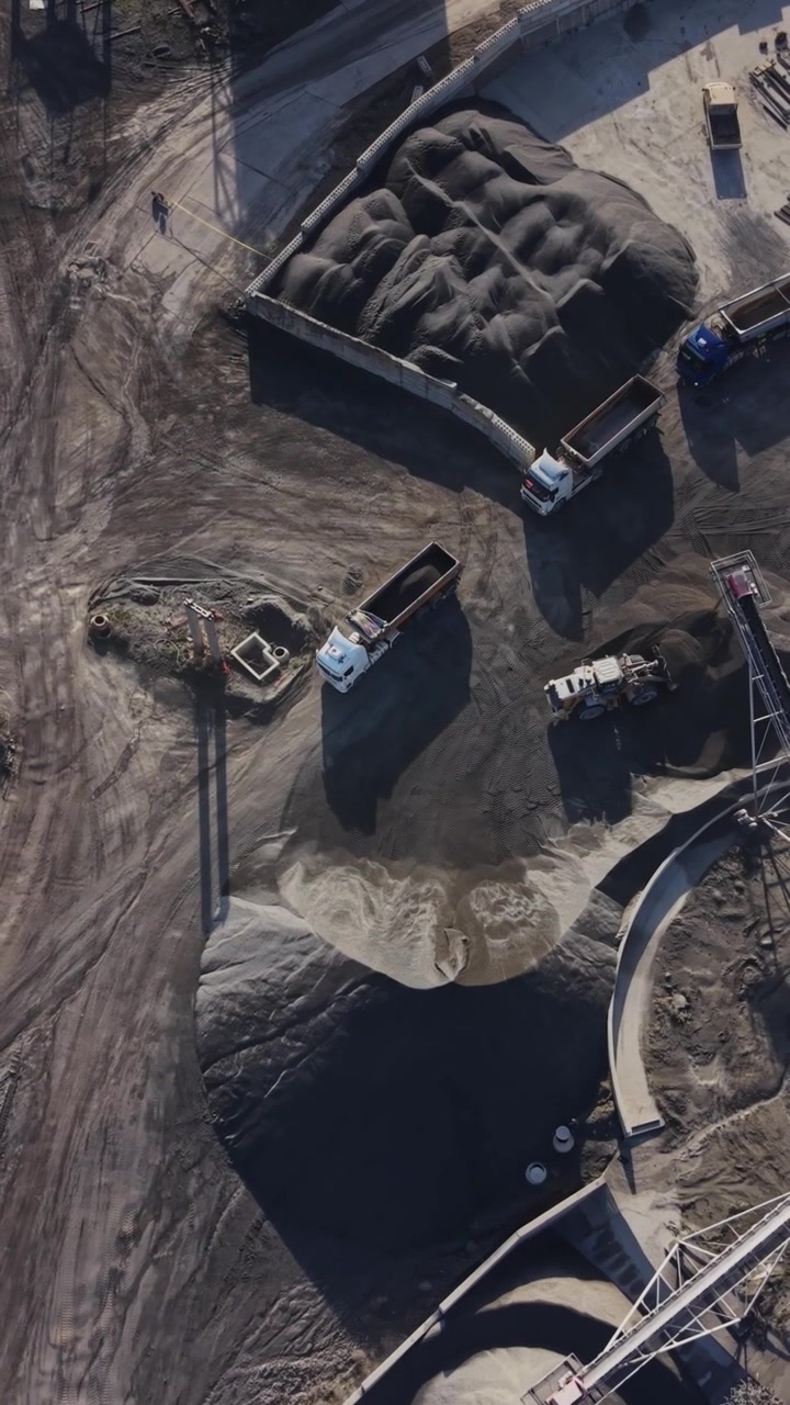 View of quarry with equipment and materials at mining site in daytime