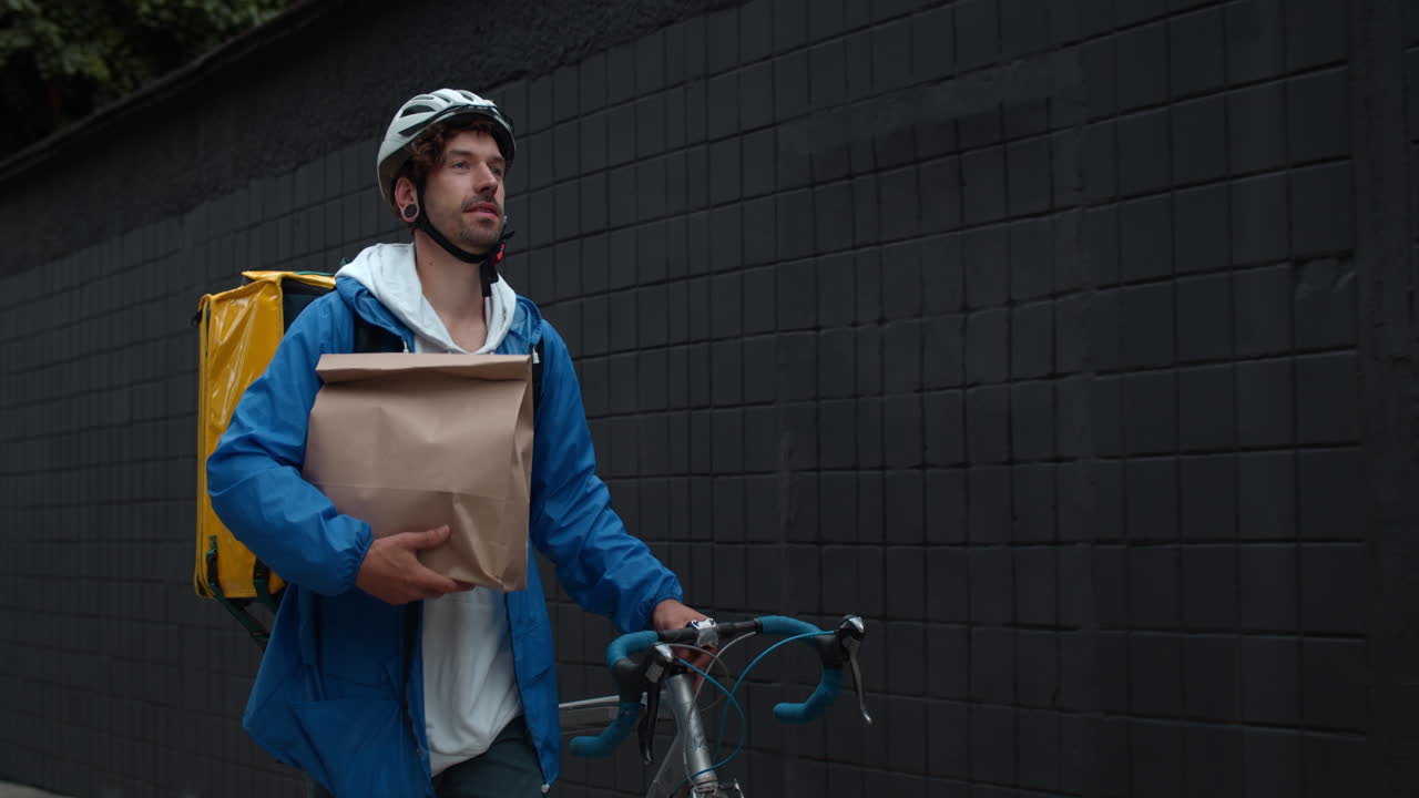 Food delivery cyclist with a paper bag