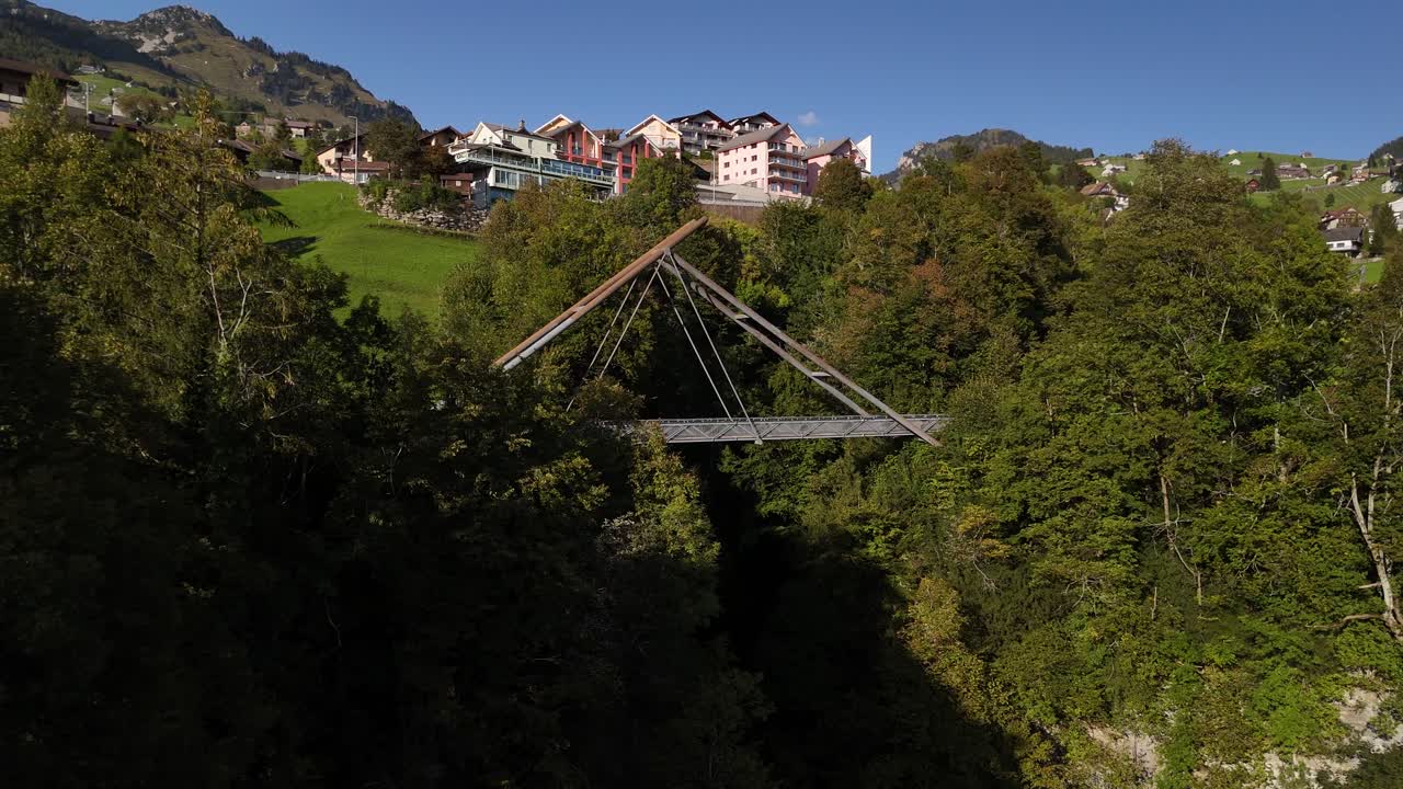 Bridge over valley Switzerland mountain alpine village resort, forest covered