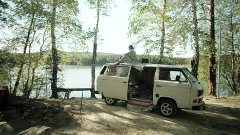 woman resting on roof of camper van