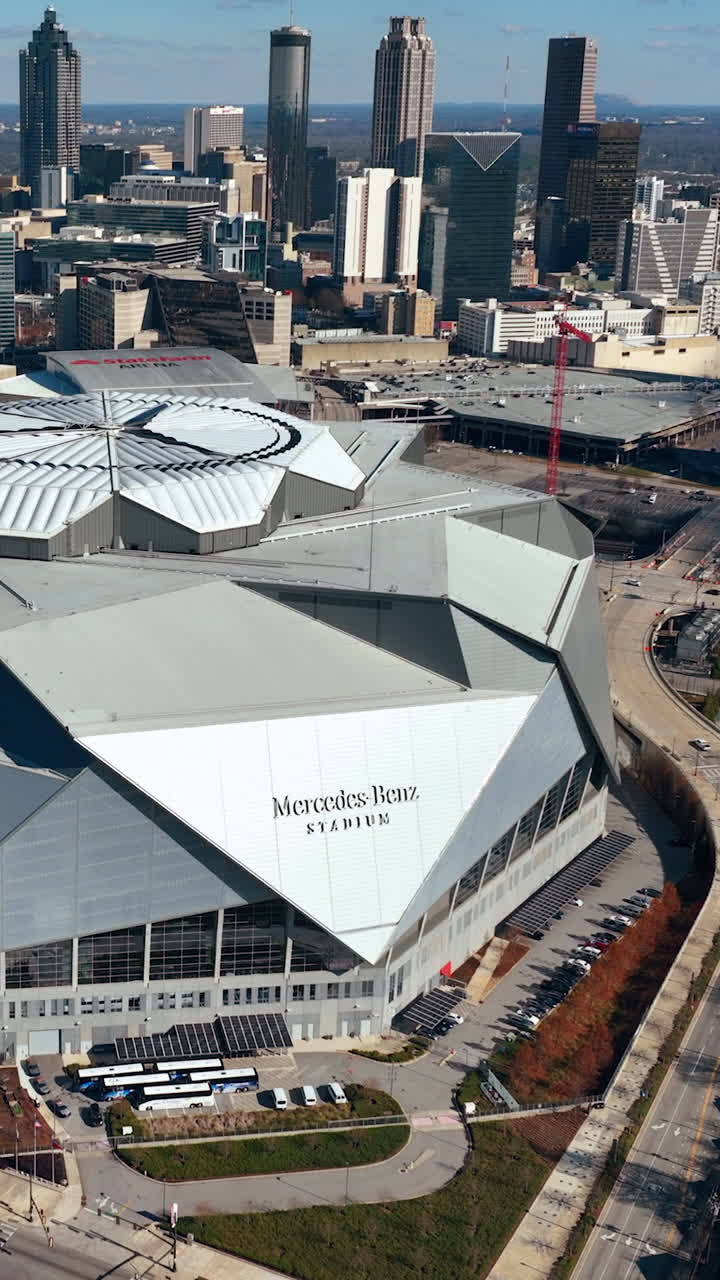 Atlanta, Georgia, USA - January 02, 2024: Winter aerial top view of the central part of the city with a building of Mercedes-Benz Stadium. Zoom in. Vertical video