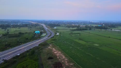 Aerial:-Drone-above-a-curve-on-the-Highway-before-entering-the-city-early-in-the-morning