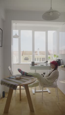 mujer trabajando desde casa en una cocina acogedora
