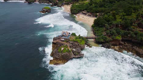 Aerial-view-of-coral-island-on-the-beach-hits-by-the-wave