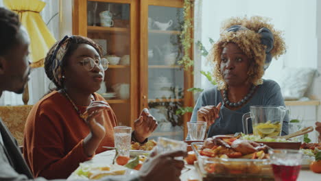 african american relatives having conversation on holiday dinner at home