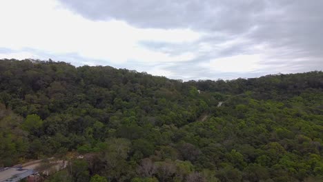 Drone-shot-Argentina-Santa-Ana-House-and-Road-in-the-Forest-with-midday-afternoon-blue-sky-cloudy-landscape-around-Santa-Ana