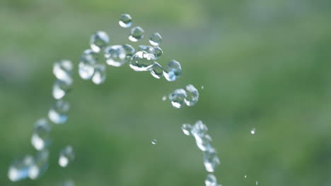 Pure-water-droplets-passing-camera-in-Slowmotion-with-green-background---180fps