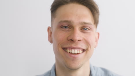 portrait of blond man smiles and looks at the front